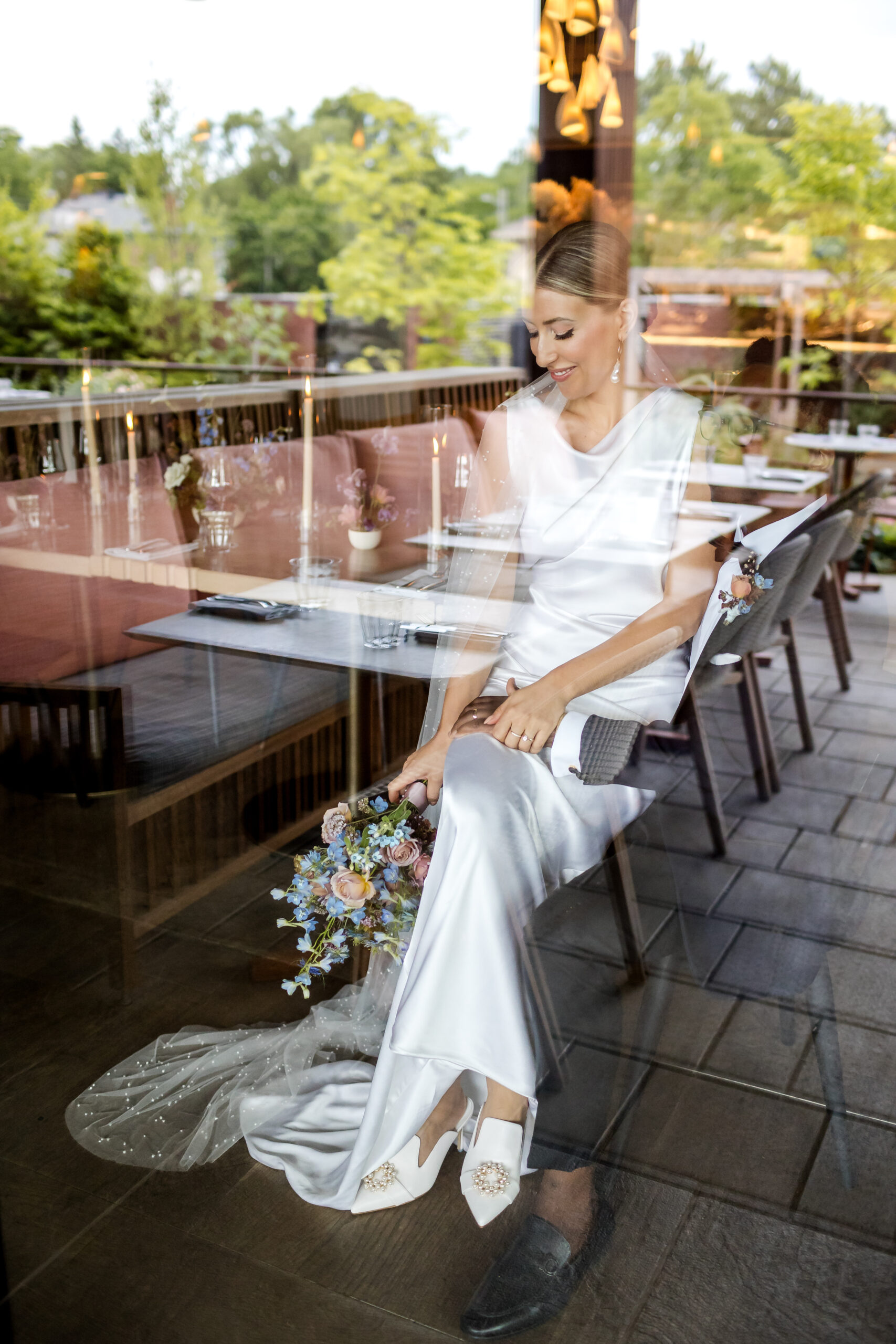 Bride sitting in the dining room looking in through a window